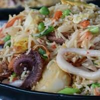 Seafood Fried Rice · Rice with shrimp, scallops, crab meat, eggs, peas, carrots, and onion.