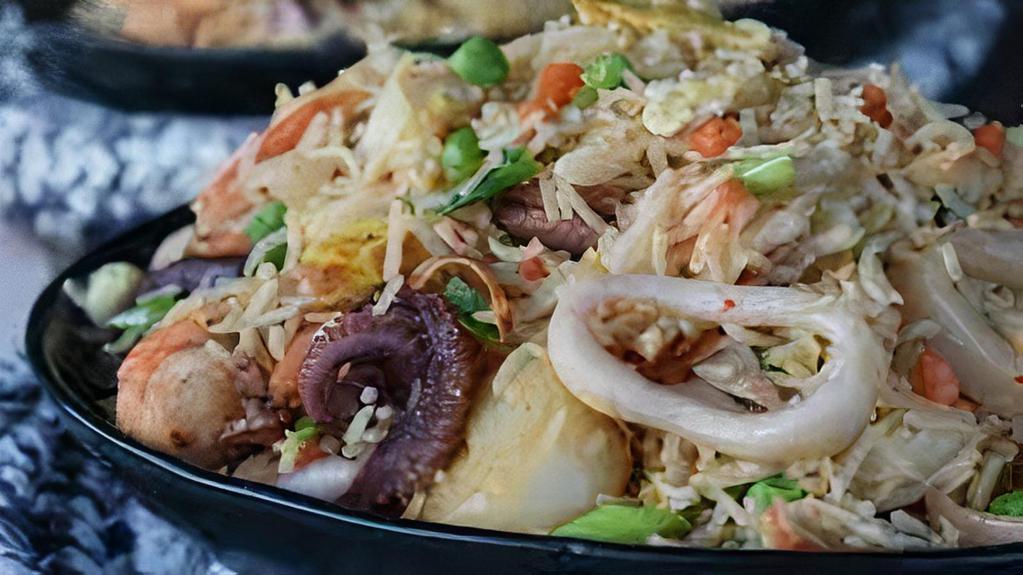 Seafood Fried Rice · Rice with shrimp, scallops, crab meat, eggs, peas, carrots, and onion.