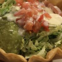 Taco Salad · Ground beef or shredded chicken in a crispy tortilla bowl topped with lettuce, sour cream, g...