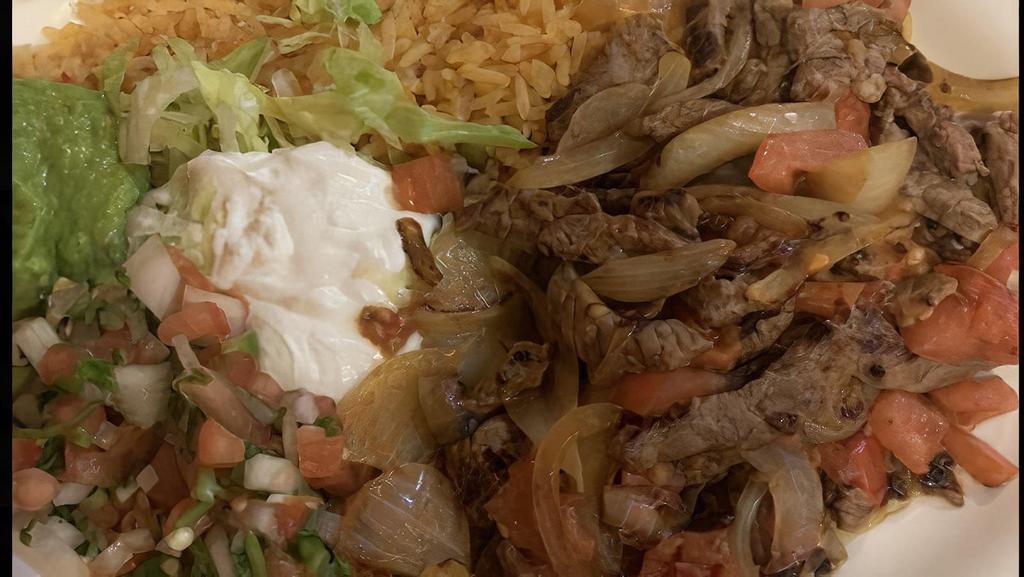 Fajitas · Steak, chicken, or mix sautéed with onions, bell peppers, and tomatoes. Served with rice, beans, and tortillas.