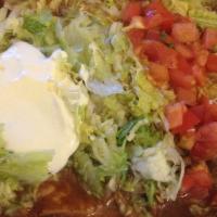 Enchiladas Supreme · One chicken, one bean, one cheese, and one beef enchiladas, topped with red sauce, lettuce, ...