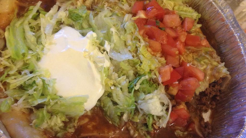 Enchiladas Supreme · One chicken, one bean, one cheese, and one beef enchiladas, topped with red sauce, lettuce, tomatoes, sour cream, and shredded cheese.