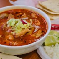 Caldo Pozole · Pork stew served with lettuce, onions, cilantro, slices of avocados and an order of tostadas.