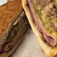 Cuban · fresh roasted pork grilled ham and salami with Swiss cheese yellow mustard and pickles press...