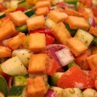 Fattoush · Vegan. Gluten-free (without pita chips). Tomato, cucumber, onion, and bell peppers in a garl...