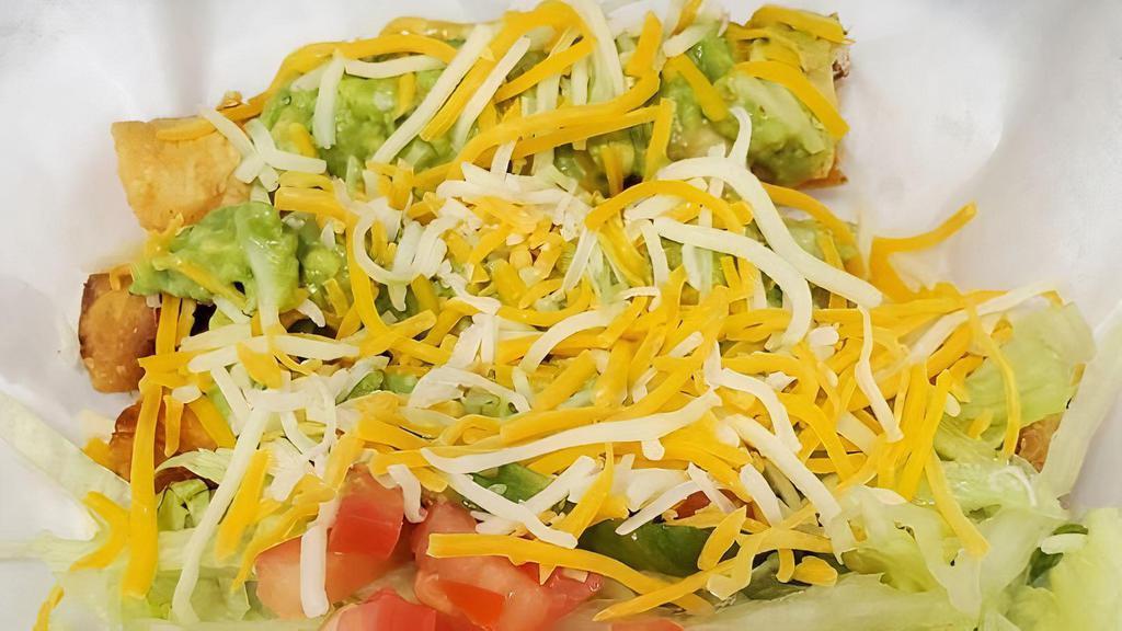 3-Rolled Tacos · Made with shredded beef and topped with guacamole, lettuce, tomato and cheese.