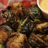 Fried Sprouts · Brussels sprouts lightly fried, salted, and served with our zesty sriracha aioli.