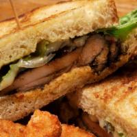 Jerk Chicken Sandwhich · Jerk chicken thighs on toasted sourdough with grilled onions, melted provolone, lettuce, and...