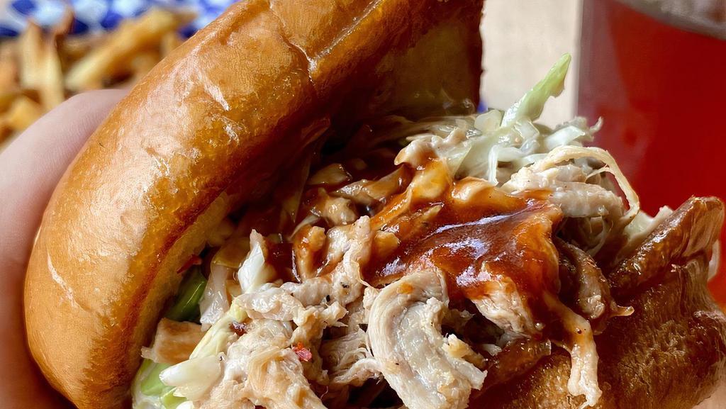 Pulled Pork Bbq Sandwich · Topped with slaw served on a butter-toasted bun and your choice of one side.