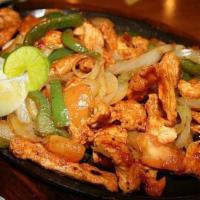 Fajitas · Tender beef or chicken sautéed with bell peppers, tomatoes and onions. Served with sour crea...