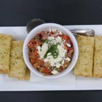 Bruschetta · Fresh roma tomatoes, red onions, tossed with pesto vinaigrette and topped with feta cheese a...