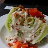 L.T Wedge (Regular) · Crisp iceberg wedge dressed with smoked bacon, fresh roma tomatoes and chunky bleu cheese.