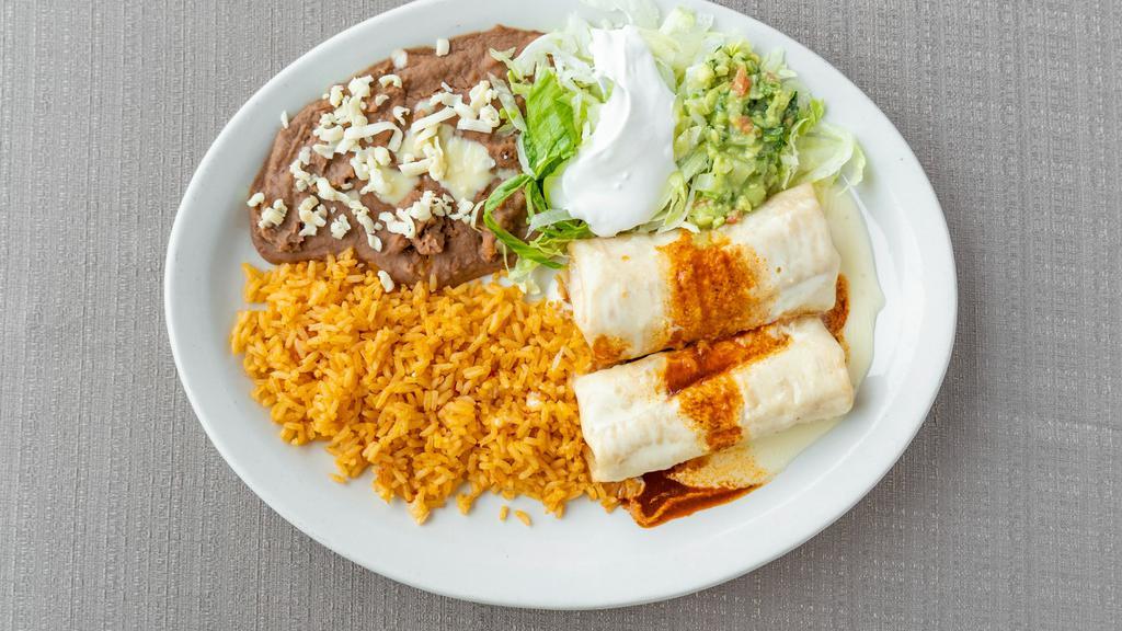Chimichangas · Two fried chimichangas filled with either beef or chicken. Topped with cheese and red sauce. Served with rice and beans, lettuce, tomatoes, sour cream and guacamole.