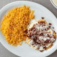 Pollo Toluca · Grilled chicken breast covered with chorizo and cheese. Served with rice and three tortillas.