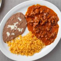 Chile Colorado · Steak with hot sauce, rice and beans and three tortillas.