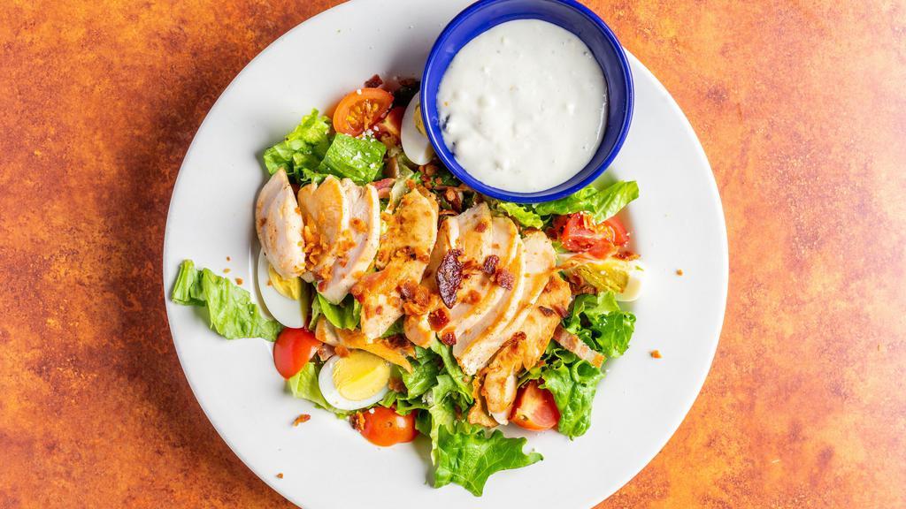 Cobb Salad · with grilled chicken, blue cheese, bacon, tomatoes, & egg.