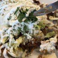 Cochinita Pibil Huarache · Shredded pork. Hand crafted corn tortilla topped with refried beans, queso fresco, lettuce a...