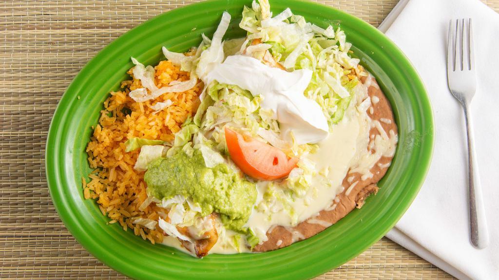 Chimichangas · EITHER FRIED OR SOFT STUFFED BURRITO WITH YOUR CHOICE OF MEAT TOPPED WITH OUR HOMEMADE QUESO, LETTUCE, SOUR CREAM, TOMATO & GUACAMOLE. SERVED WITH RICE AND BEANS