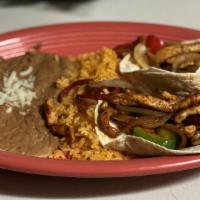 Taco Fajita · Two flour tortillas filled with grilled chicken or steak, grilled peppers and onions served ...