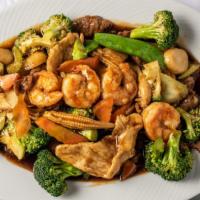 Triple Delight · Tender white chicken, beef, jumbo shrimp sauteed with mixed garden vegetable and broccoli in...