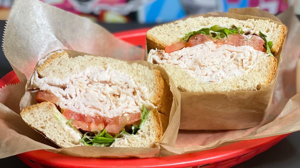 Harvest Turkey · Oven roasted turkey, tomato, cranberry mayo and mesclun greens served on deli wheat.