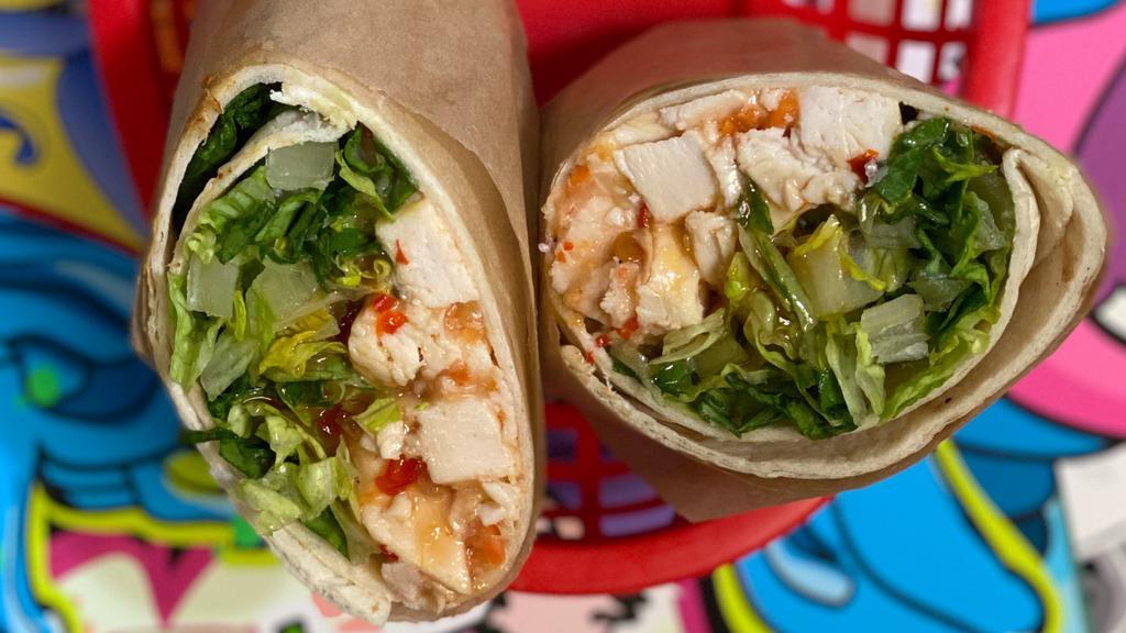 Thai Chicken · Our homemade thai chicken mix with sweet chili sauce and romaine lettuce, served cold and wrapped in a flour tortilla.