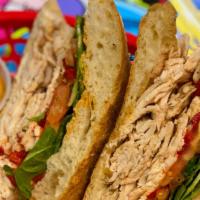 Tuscan Chicken · Sliced grilled chicken, roasted red peppers, mesclun greens, tomato and homemade chipotle sa...