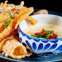 Chips Con Queso · White cheese dip served with tortilla chips.