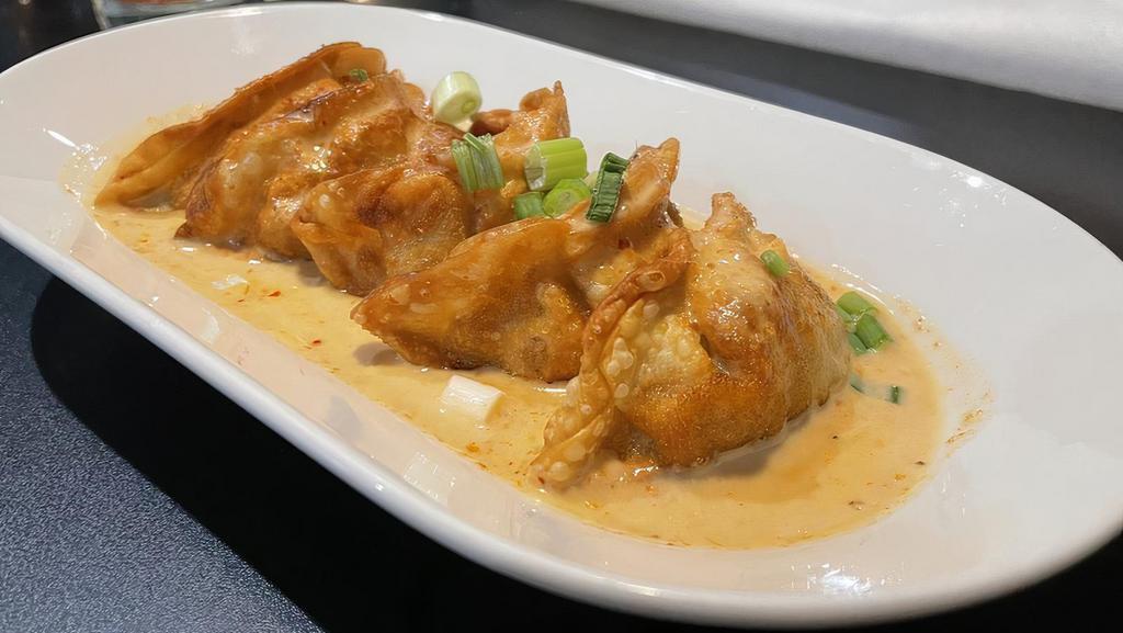Curry Potstickers (5) · Pan seared chicken and vegetable dumplings, topped with a red curry basil glaze.
