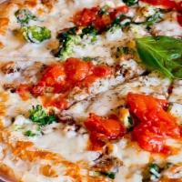 Tommy P · Sesame seed crust, broccoli, spinach, eggplant, feta, mozzarella cheese topped with marinara...