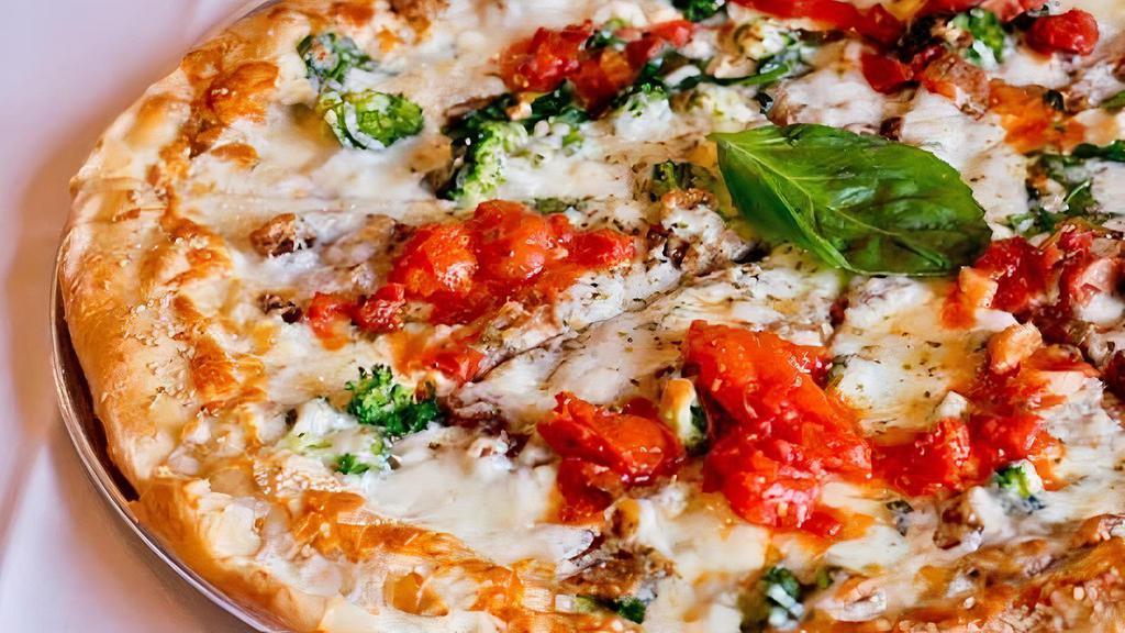 Tommy P · Sesame seed crust, broccoli, spinach, eggplant, feta, mozzarella cheese topped with marinara sauce