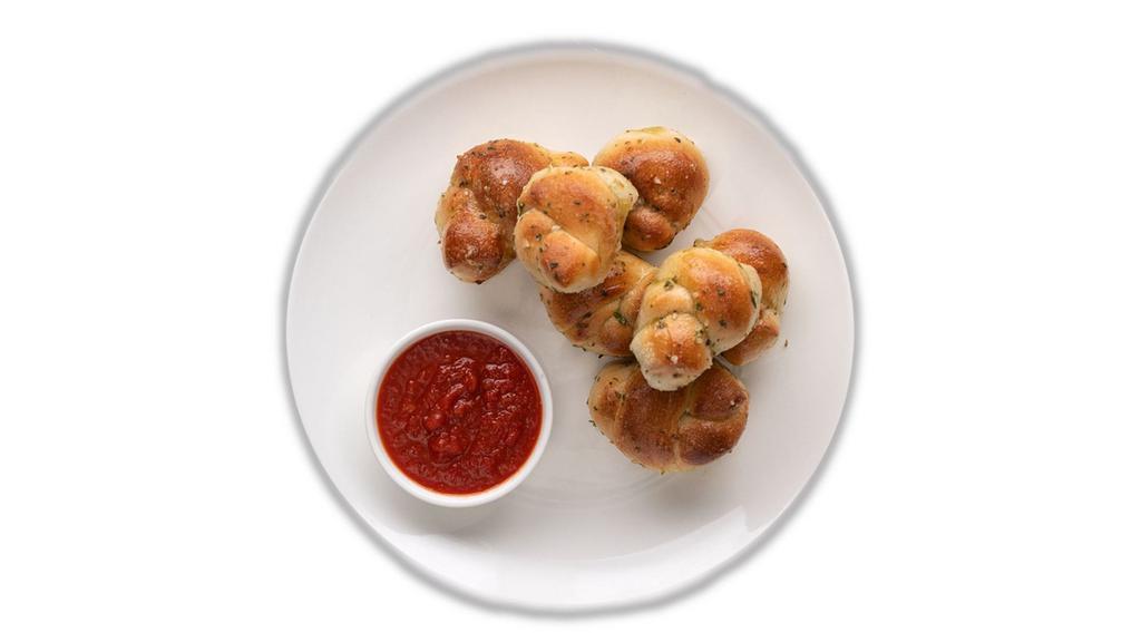 Garlic Knots (6) · Freshly Baked with savory blend of Fresh Garlic, Virgin Olive Oil, Oregano & Parsley finished with Parmesan