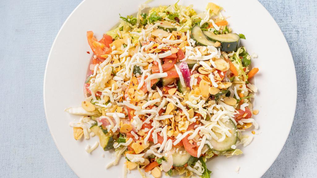 Spicy Cucumber Salad · Two types of lettuce thinly sliced with cilantro and basil, tossed with cucumbers, Roma tomatoes, red onions and shredded mozzarella cheese in a zesty vinaigrette topped with spiced almonds. (Spicy)
