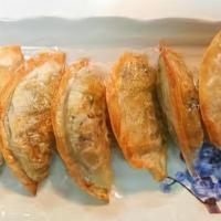 Yaki Mandu (8Pc) · Eight gourmet fried dumplings with homemade dipping sauce.  Pork or/and beef contained.