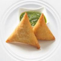 Famous Indian Veg Samosa · Hot fried pastry shells stuffed with roasted cumin potatoes, served with mint and tamarind c...