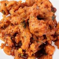 Traditional Onion Pakora · Mouthwatering crisp onions golden fried in a seasoned chickpea batter.