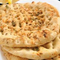 Garlic Naan · Flatbread sprinkled with crushed garlic, cheese and baked in tandoor oven.
