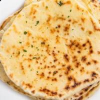 Naan · Leavened flatbread made from white flour and baked in tandoor oven.