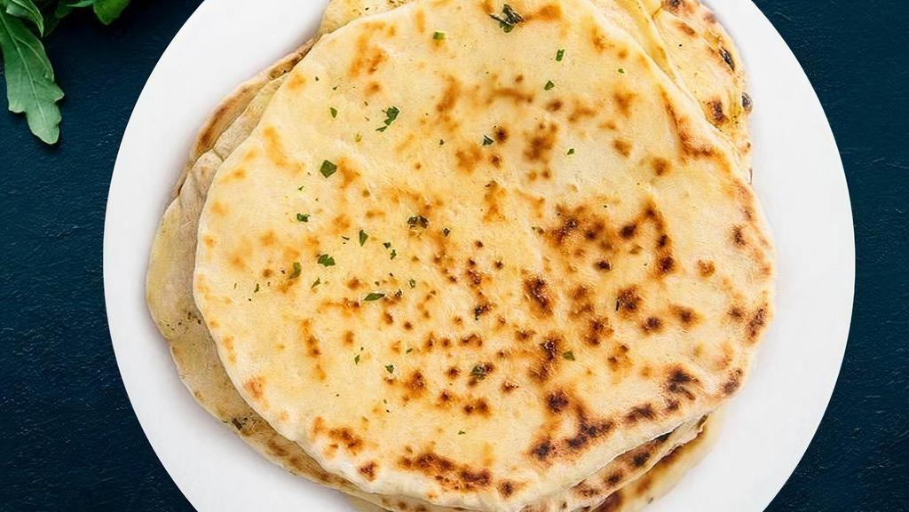 Naan · Leavened flatbread made from white flour and baked in tandoor oven.
