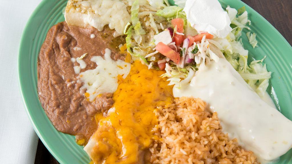 Trio Enchiladas · Combination of three enchiladas: one chicken, one cheese, and one beef. Topped with three different enchilada sauces and served with sour cream.