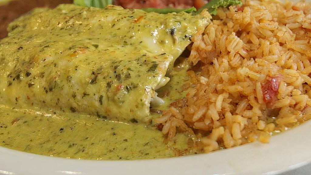 Enchiladas Borrachas · Two enchiladas filled with cheddar cheese and chicken, topped with a creamy tequila cilantro pecan sauce.