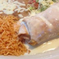Fajita Chimichanga · Filled with fajita style chicken and melted cheddar, then topped with cheese dip. Served wit...