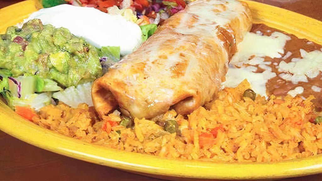 Santa Fe Chimichanga · Your choice of chicken or ground beef topped with a poblano queso dip, served with guacamole and sour cream and rice and beans.