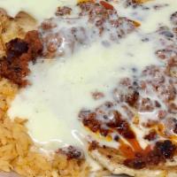 Choripollo · CHICKEN BREAST TOPPED WITH HOMEMADE CHORIZO AND CHEESE DIP SERVED WITH RICE AND BEANS