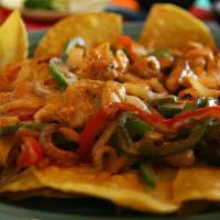 Chicken Fajita Nachos · Corn tortilla chips topped with beans chicken, fajitas with grilled  onions and green pepper...