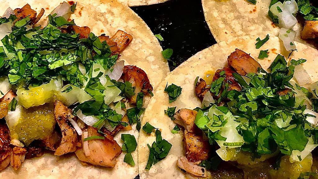 Pollo Asado Tacos · 3 tacos on marinated grilled chicken topped with onions and cilantro