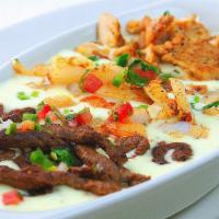 El Real Dip · Steak, chicken, shrimp and pico de gallo over cheese dip.

Foods cooked to order, consuming ...
