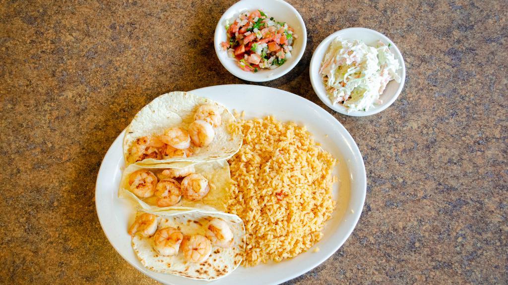 Shrimp Tacos · Three flour or corn tortillas with shrimp garnished with creamy coleslaw. Served with rice and pico de gallo.