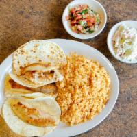 Fish Tacos · Three flour or corn tortillas with grilled tilapia garnished with creamy coleslaw. Served wi...