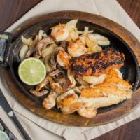 Mar Y Tierra · Tender strips of marinated chicken, steak, shrimp, tilapia, and chorizo, served on a bed of ...